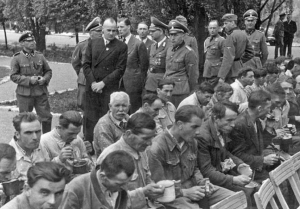Hans Frank zdecydował, że głodzenie Polaków pozwoli ich trzymać w ryzach. Na zdjęciu Frank przechadza się wśród robotników przymusowych. 