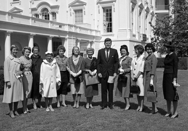 Prezydent USA John F. Kennedy z członkiniami stowarzyszenia kobiet pilotujących helikoptery w ogrodzie przy Białym Domu, 1961 r. Hanna Reitsch stoi czwarta od lewej (fot. domena publiczna).